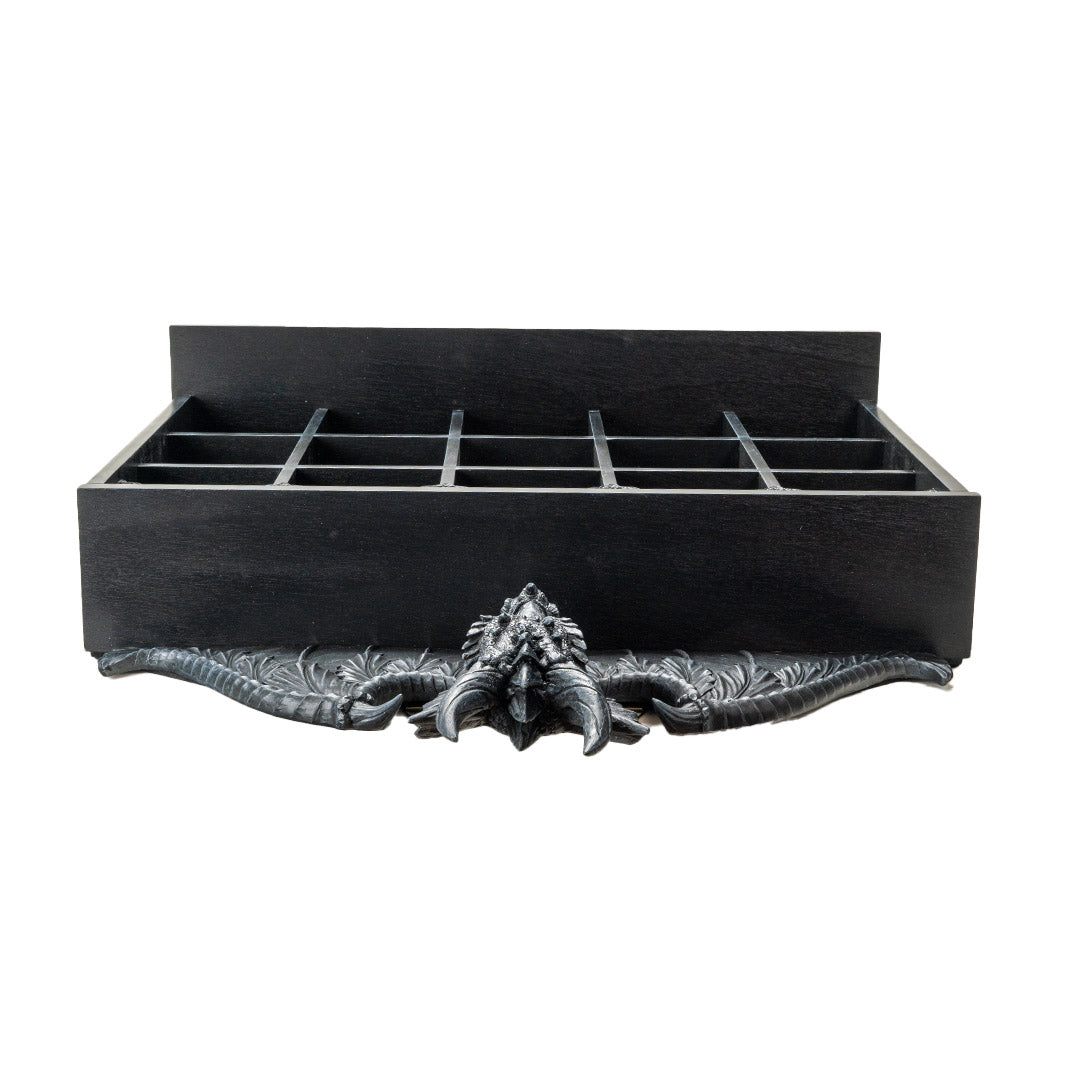 Wall shelf in black with dragon at the top, compartments and hanging rod, shown top down