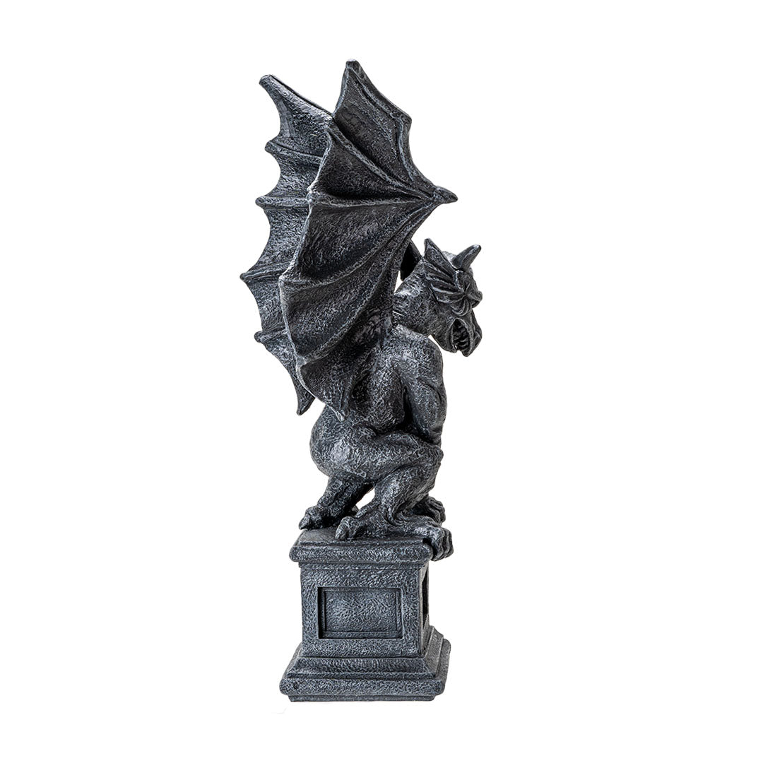 Figurine of a gray faux-stone gargoyle with dragon wings perched on a column
