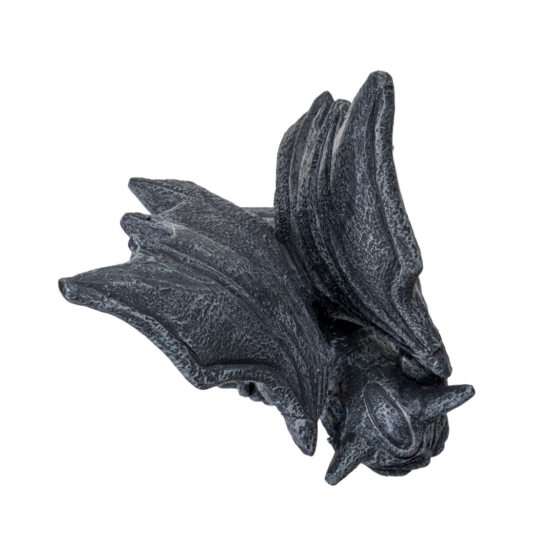 Figurine of a gray faux-stone gargoyle with dragon wings perched on a column, shown top down