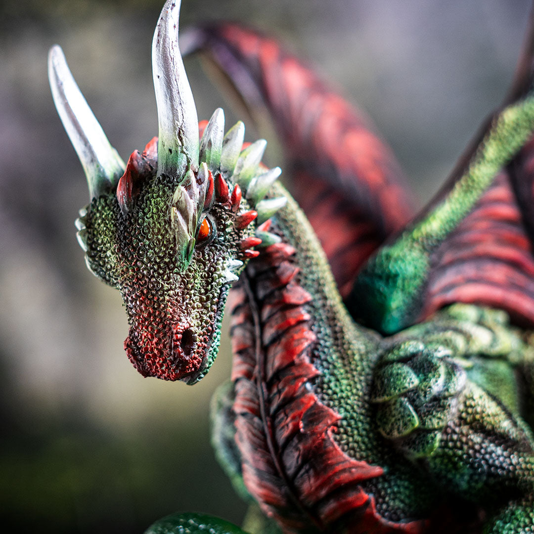 Closeup of dragon with detailed scales in green, red accents, silver horns