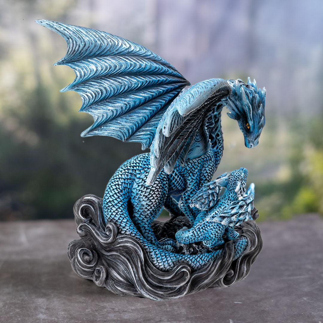 Figurine of blue dragon standing with baby hatchling, golden eyes on both, black wavy base