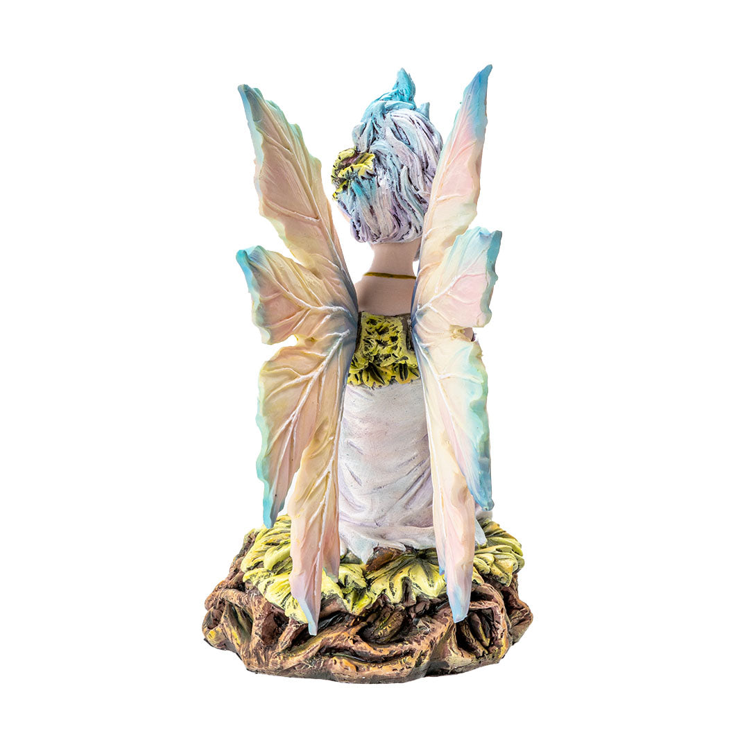 Figurine of pale fairy with pastel wings and hair seated on leafy roots, shown from the back