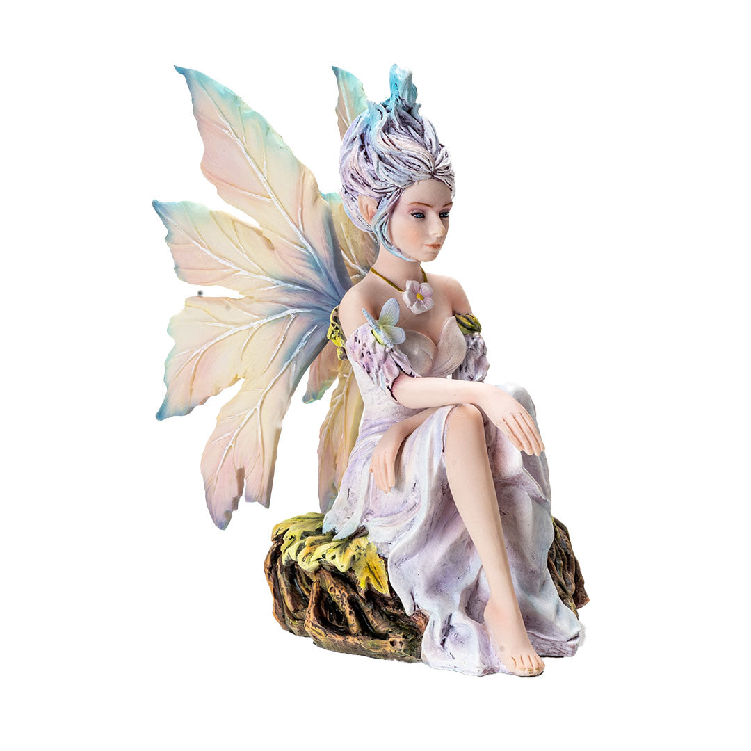 Figurine of pale fairy with pastel wings and hair seated on leafy roots with a butterfly and flower necklace