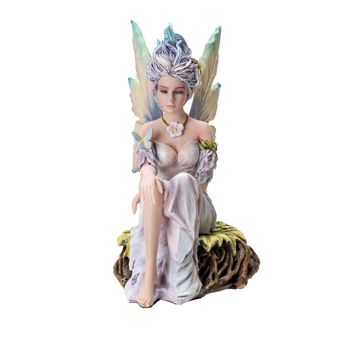 Figurine of pale fairy with pastel wings and hair seated on leafy roots with a butterfly and flower necklace