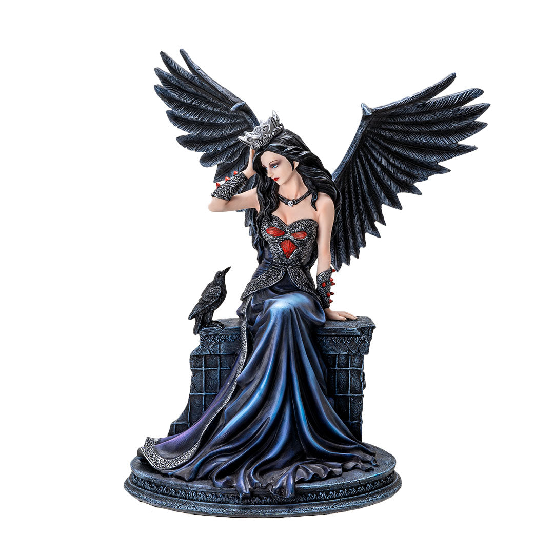 Fairy figurine, black feathered wings and hair, she wears a crown, pale skin, black and blue dress, sitting on a wall with a raven