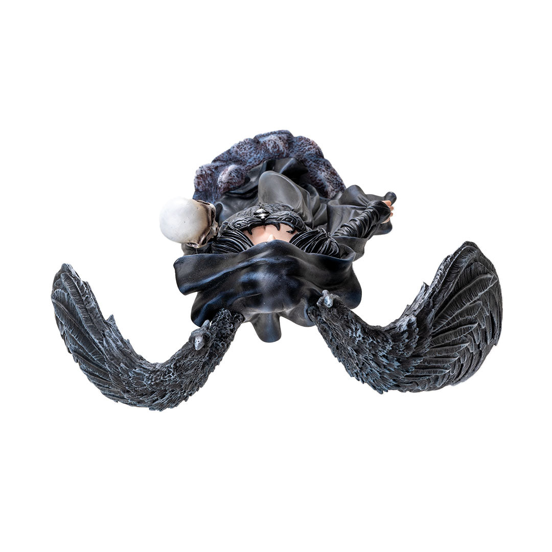 Figurine of black feather-winged angel lady in black cloak holding a skull, shown top down