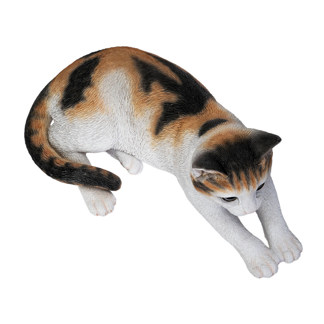 Calico cat figurine, lying down pose