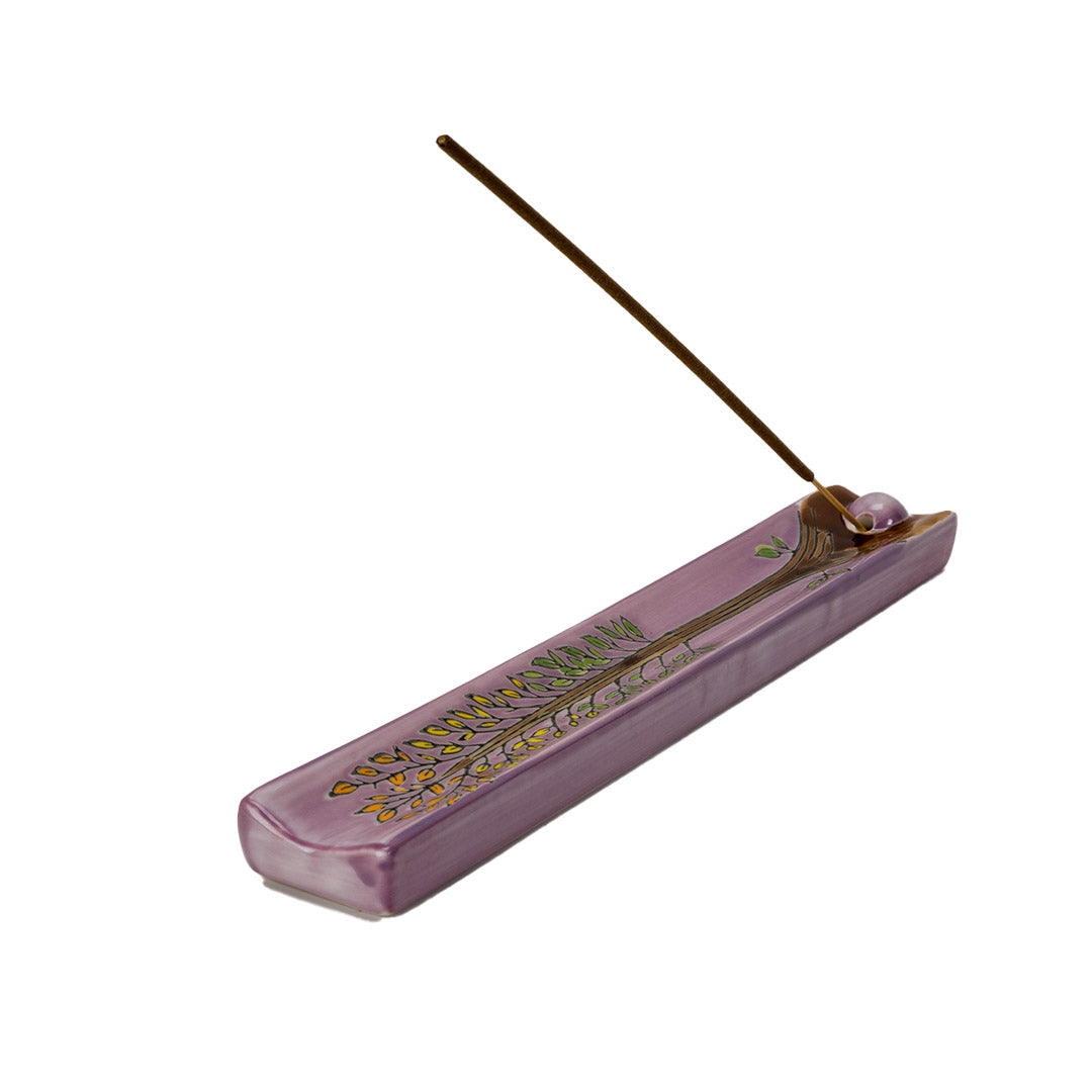 Purple ceramic incense burner with tree of life design painted on, leaves in orange, yellow and green