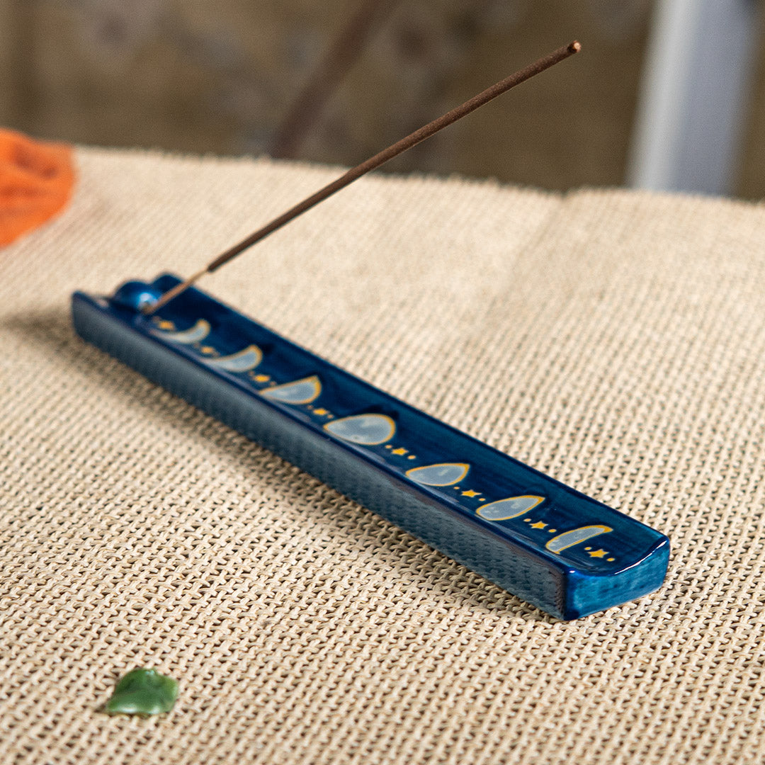 Blue ceramic incense burner/holder with the phases of the moon and stars painted on
