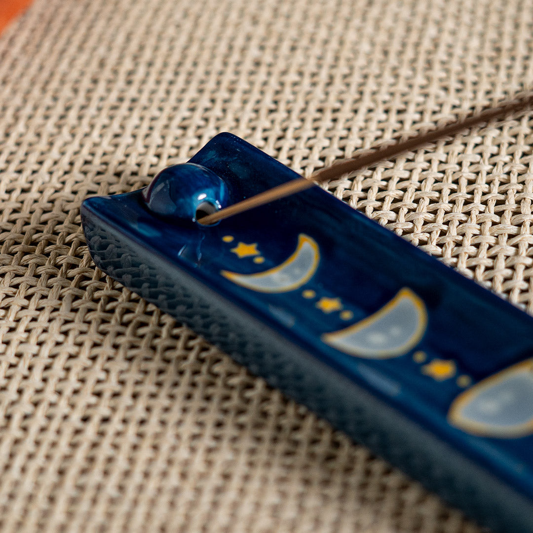 Blue ceramic incense burner/holder with the phases of the moon and stars painted on