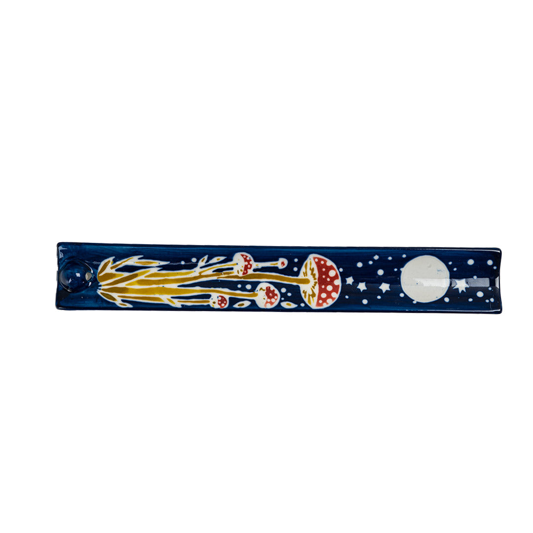 Blue ceramic incense holder with red and white mushrooms painted on under a full moon