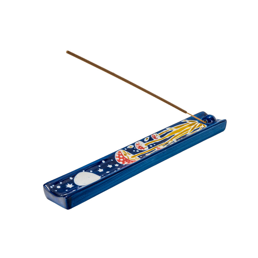 Blue ceramic incense holder with red and white mushrooms painted on under a full moon