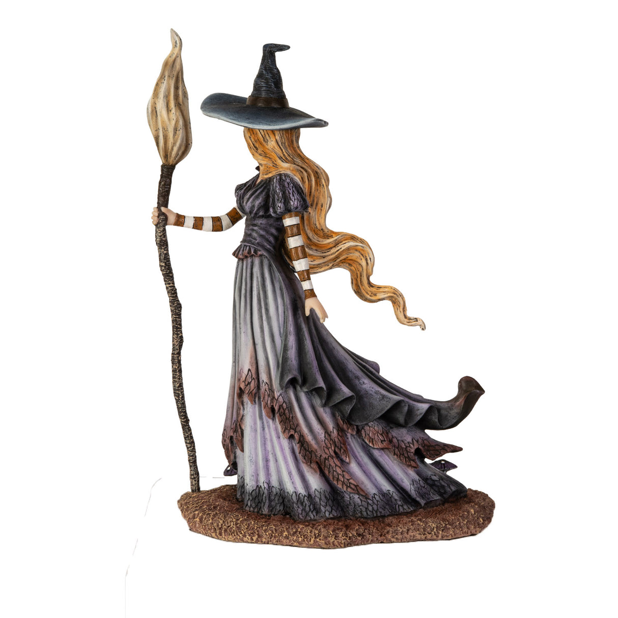 Figurine of blond witch with broom, mushrooms at her feet