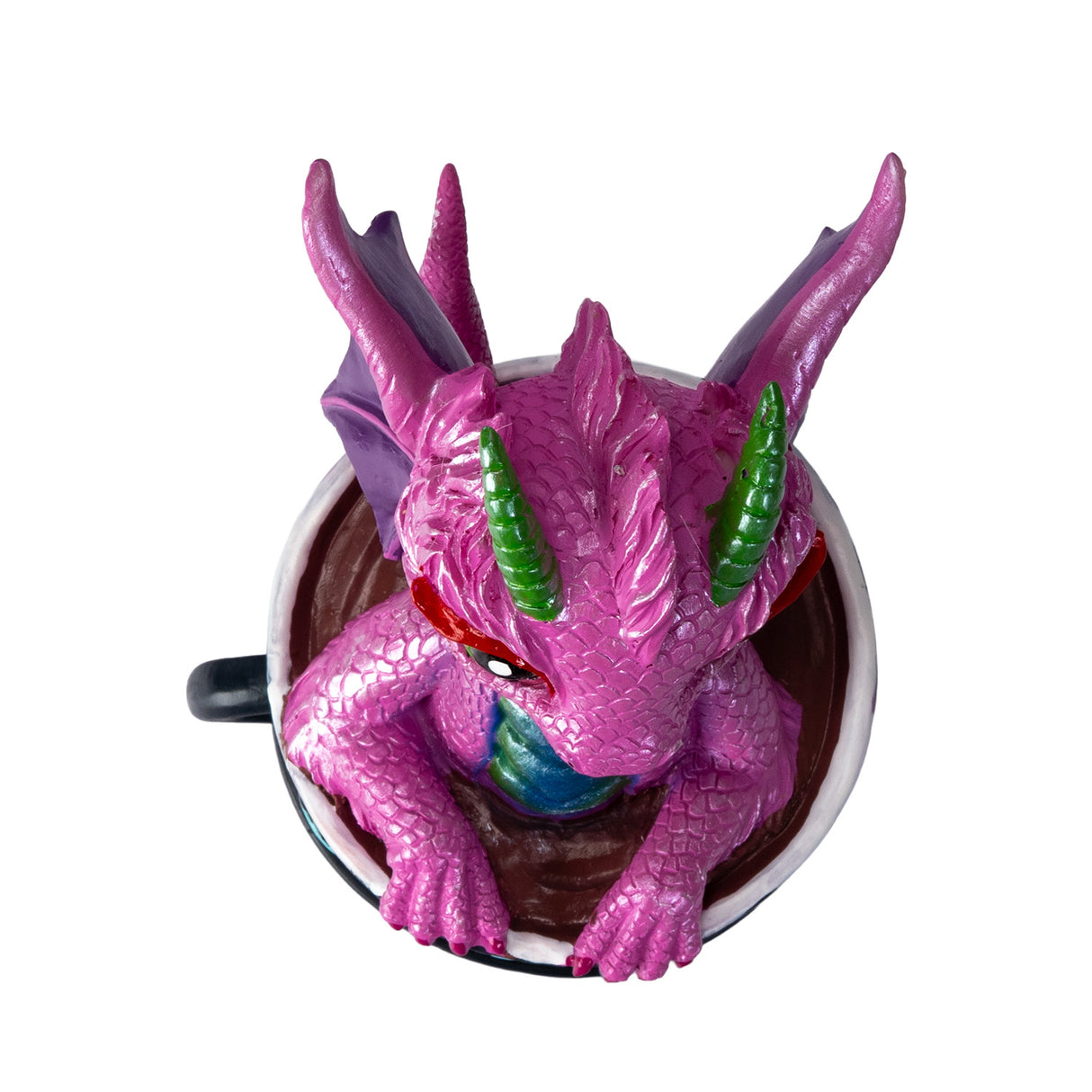 Pink dragon figurine inside a black coffee cup, shown from above