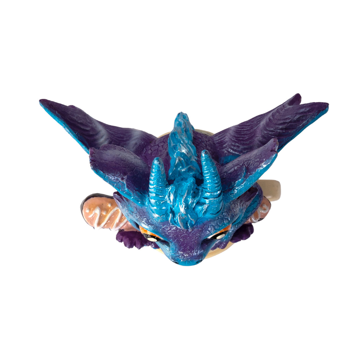 Dragon figurine on a coffee cup, shown from top down