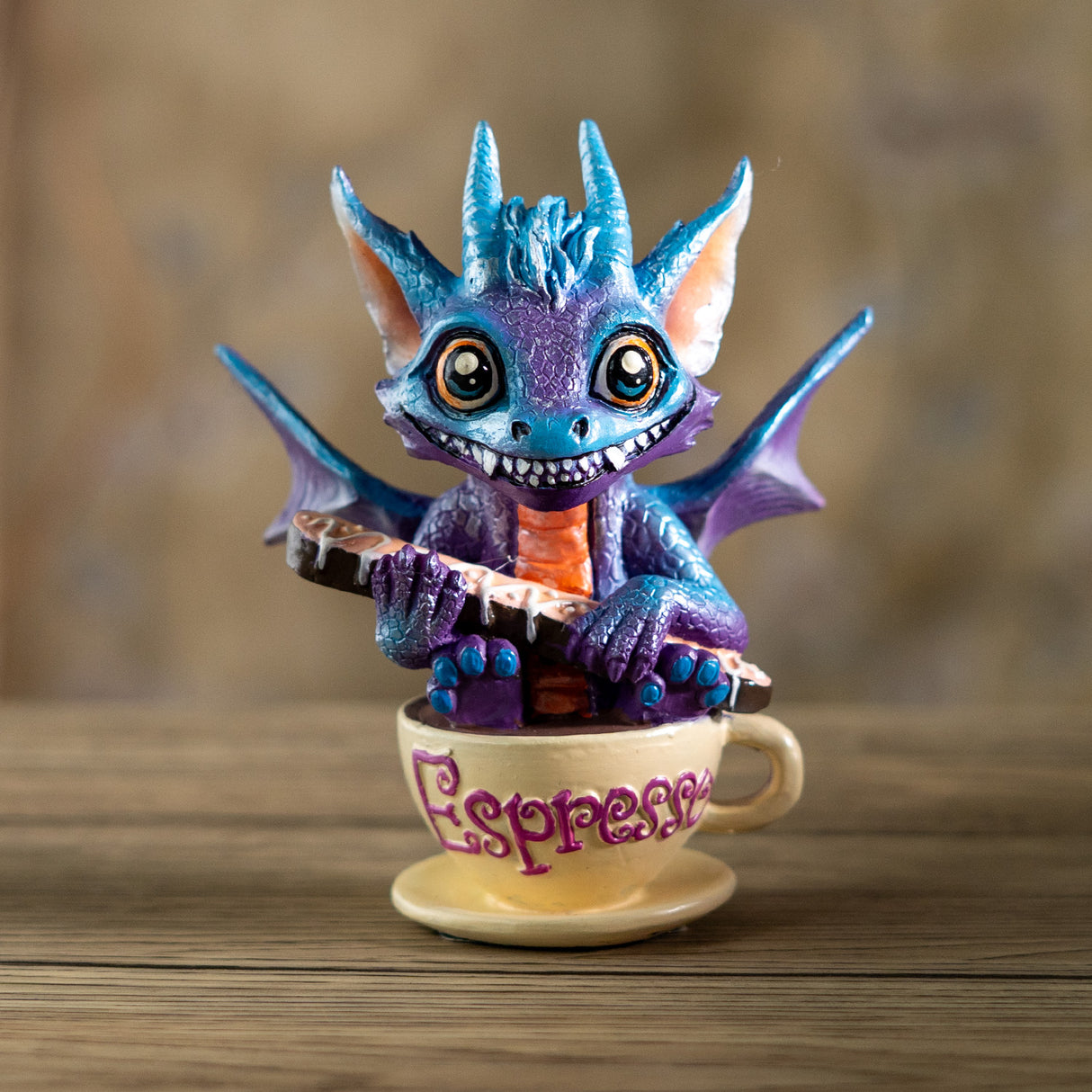 Dragon figurine on a coffee cup with "Espresso" written on it