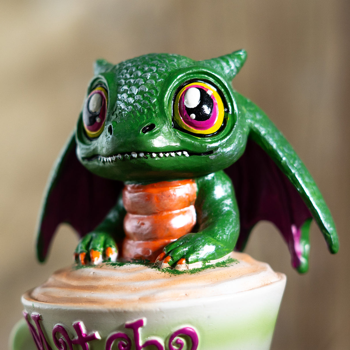 Green dragon figurine with colorful eyes