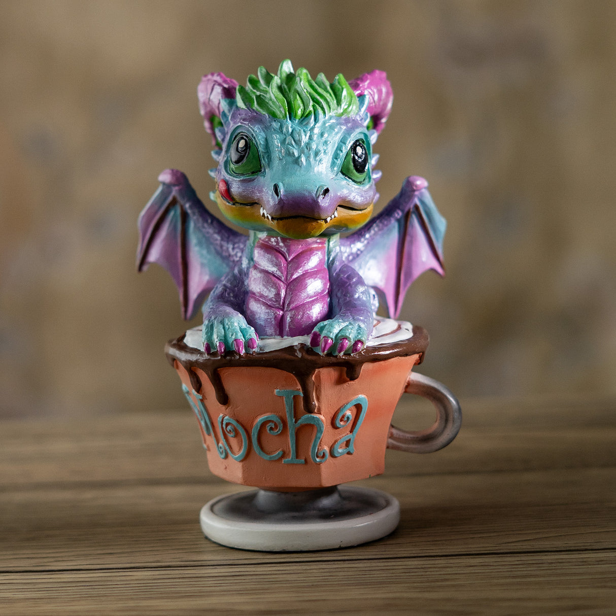Colorful dragon figurine on a small cup with 'Mocha' written on it