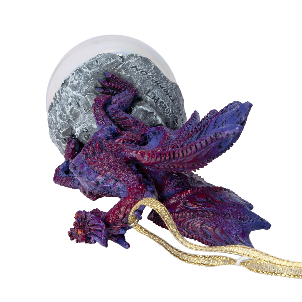 Ornament with purple dragon on rock on iridescent bubble, shown top down