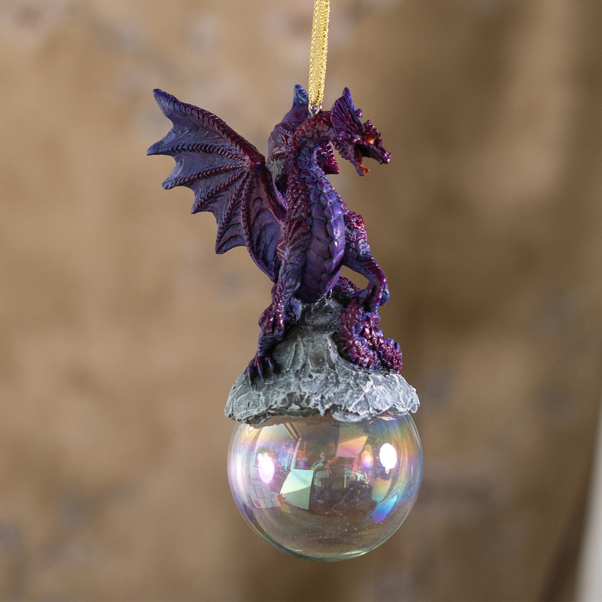 Ornament with purple dragon on rock on iridescent bubble