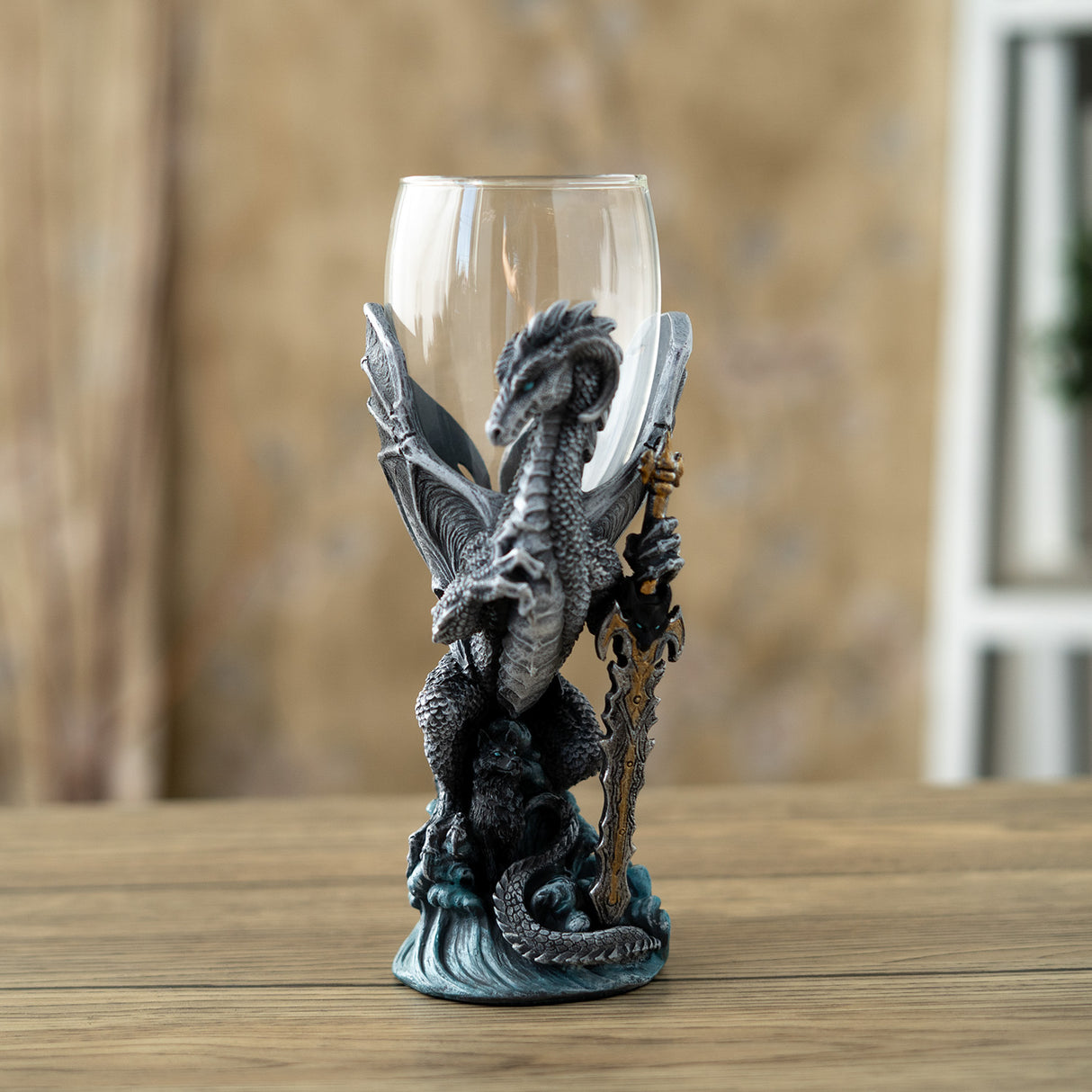 Glass topped goblet with gray dragon and black wolf, dragon is holding a sword