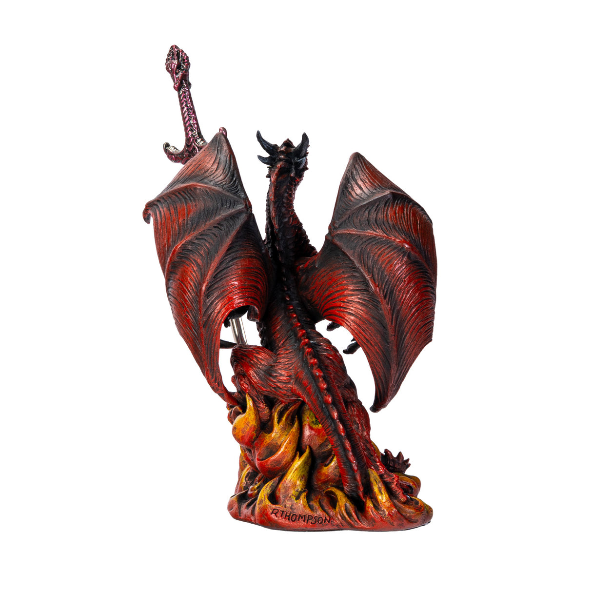 Red and orange dragon figurine holding a sword letter opener amidst flames, shown from the back