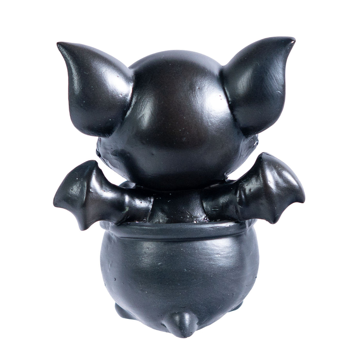 Small figurine of a black dragon imp, shown from the back, sitting in a cauldron