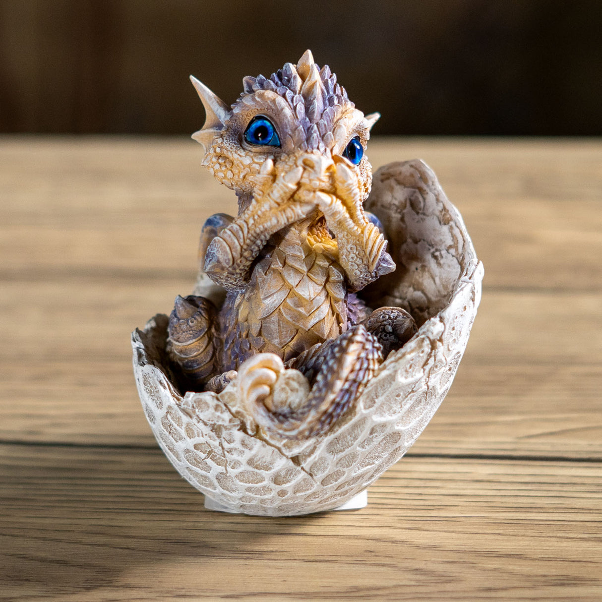 Dragon figurine hatching from an egg