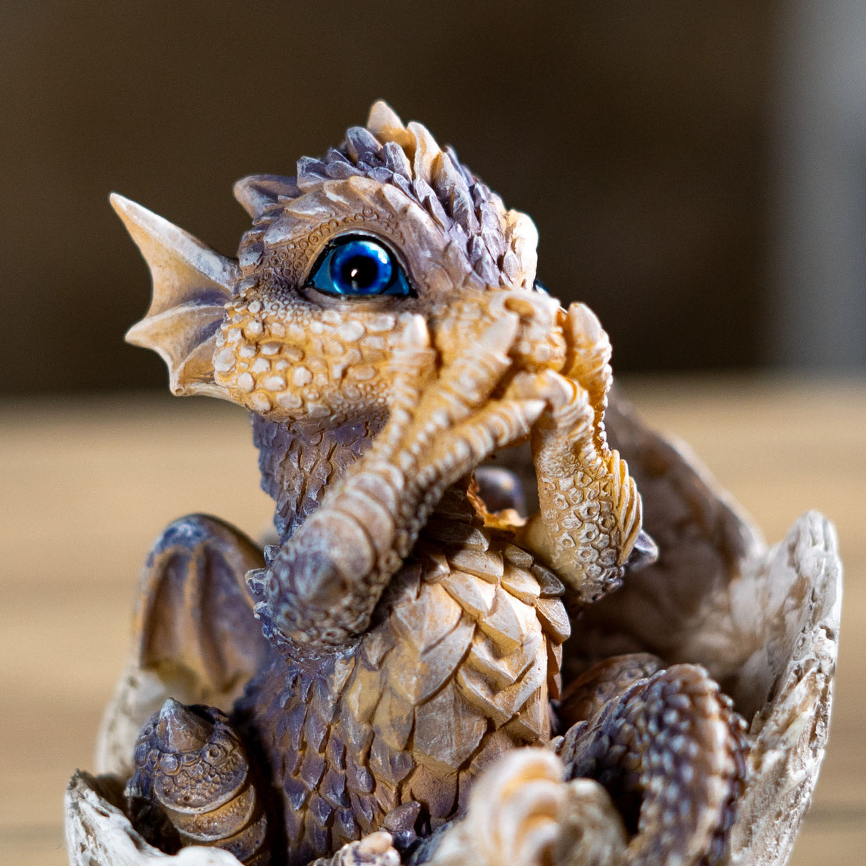 Dragon figurine hatching from an egg