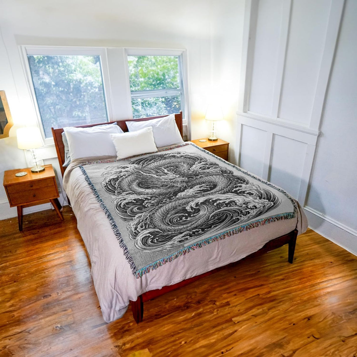 Tapestry blanket in black and white with water dragon, shown on a bed