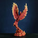 Figurine of a red, orange and yellow firebird rising from the flames