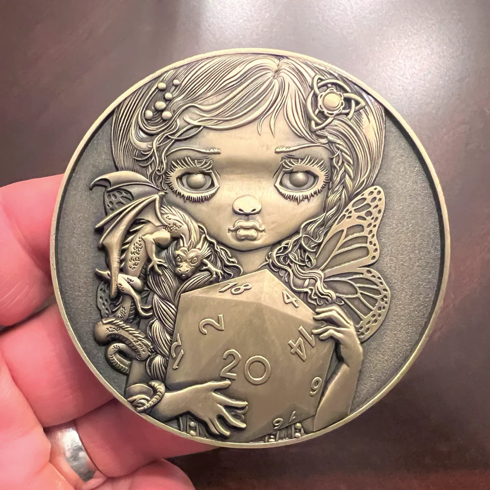 collectible metal coin with Jasmine Becket-Griffith's 20 Sided Dice, Fairy, and dragon