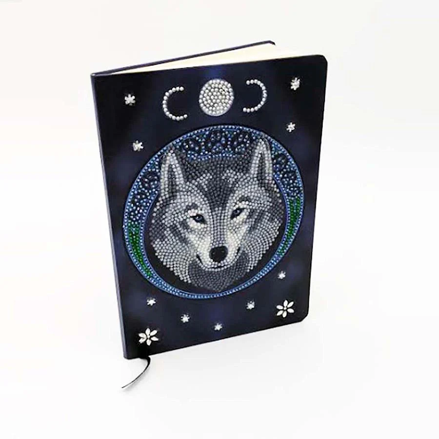 Crystal art notebook cover with white/gray wolf under moon phases on blue backdrop