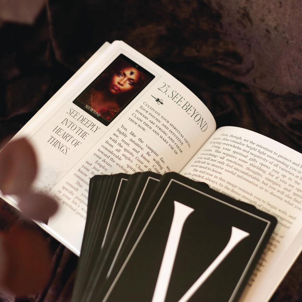 The Oracle of the Vampire Fae showing open guidebook and cards