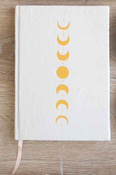 Lined notebook journal with gold printed moon phase design