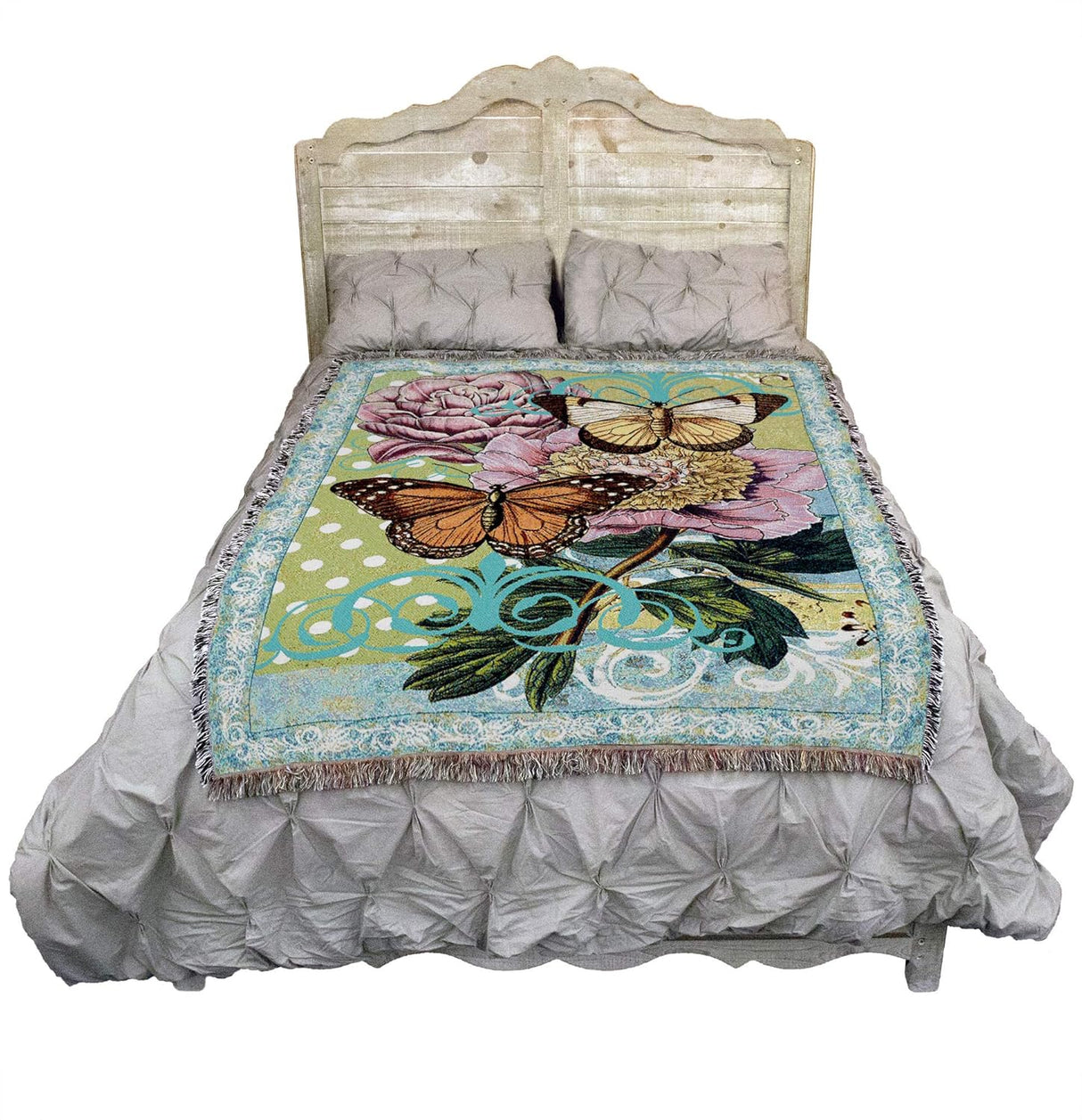 Butterfly floral blanket shown on a bed
