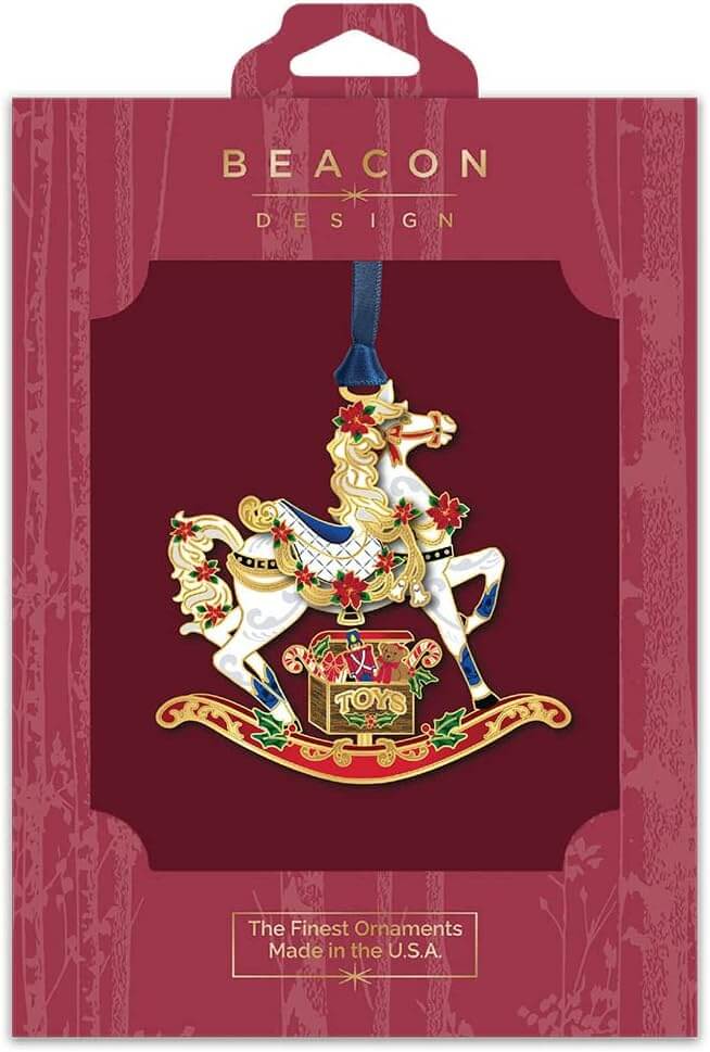 Brass rocking horse ornament with a box of toys, accented in holly and poinsettia, shown boxed