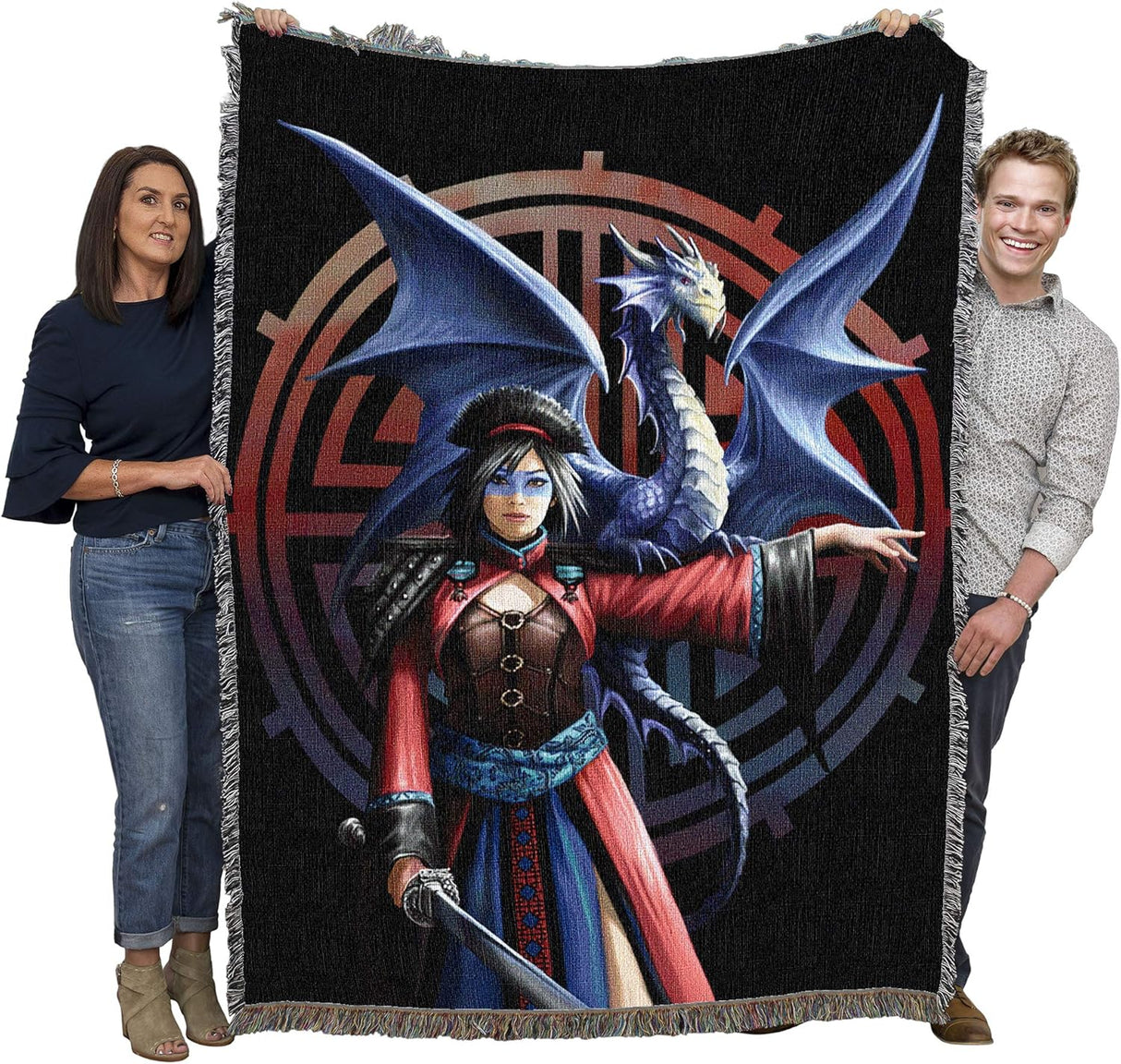 Woven blanket with a fantasy design of a dragon and warrior woman pointing, featuring a dark background with red and blue gradient symbol. Held up by two adults to show large size