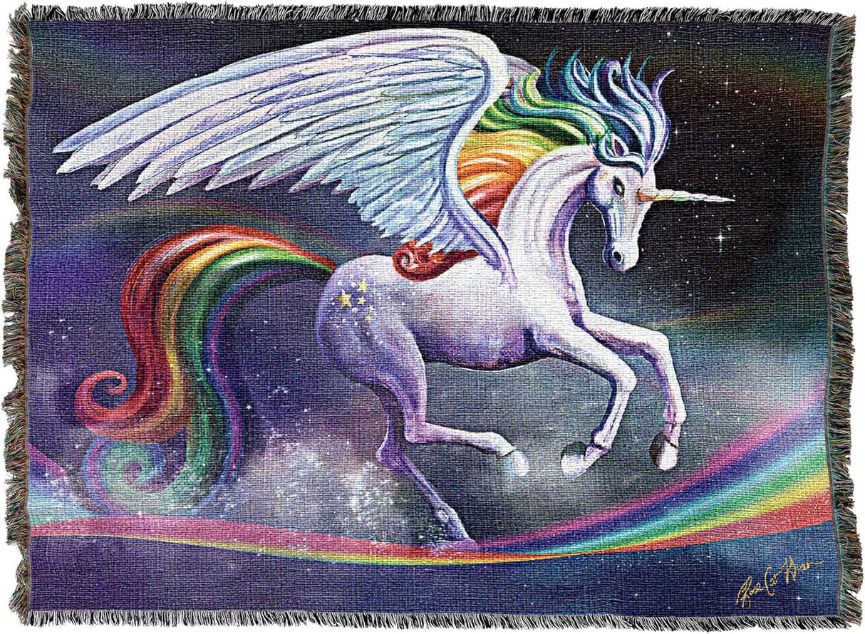 Woven blanket with a unicorn design featuring rainbow colors and a starry background. Unicorn gallops upon a rainbow in the sky