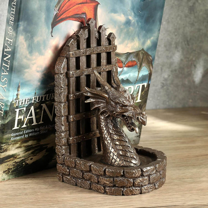 Dragon bookend shown in use holding up a book