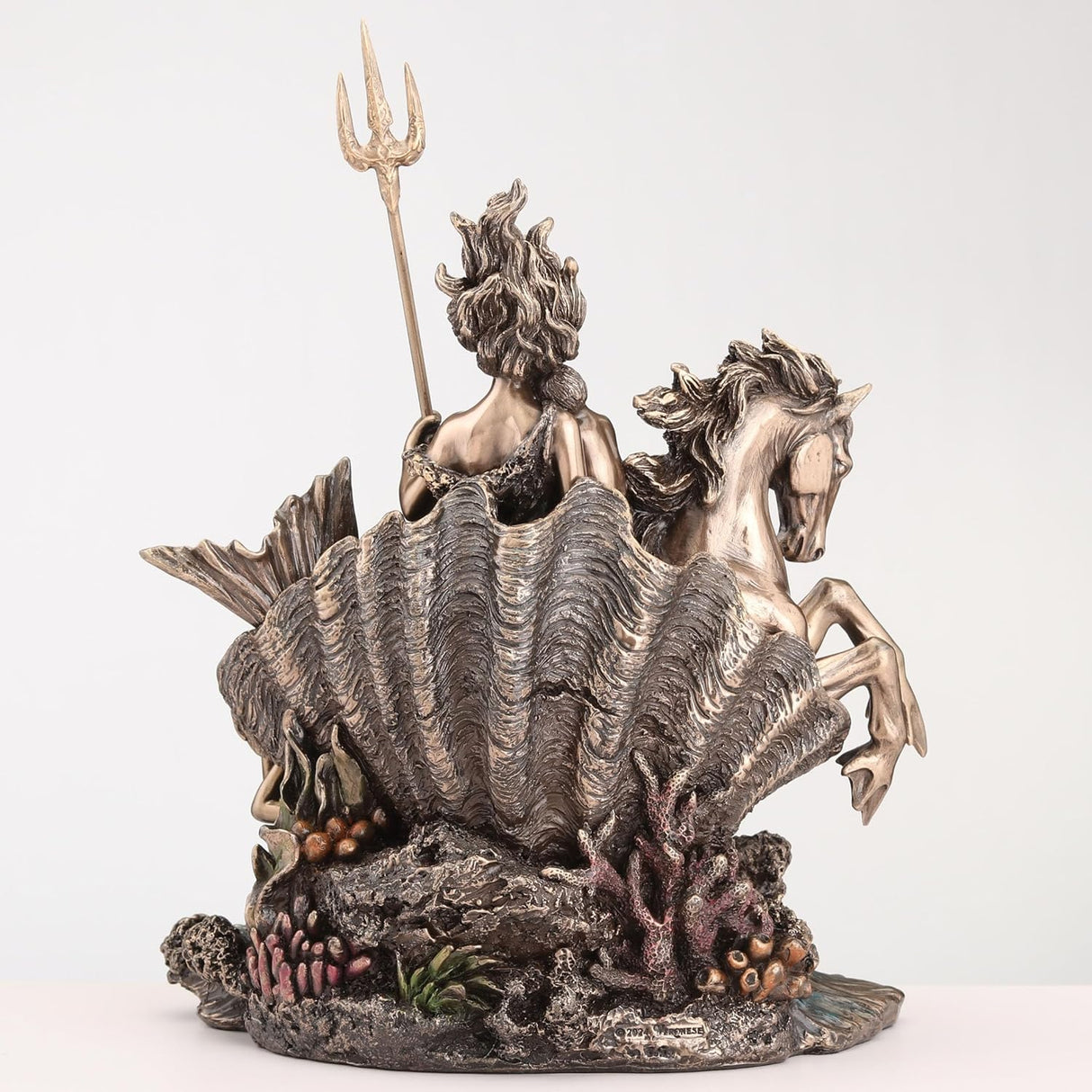 Figurine in bronze tones of Amphitrite the goddess of the sea, riding hippocampus with ocean waves and sirens, holding baby