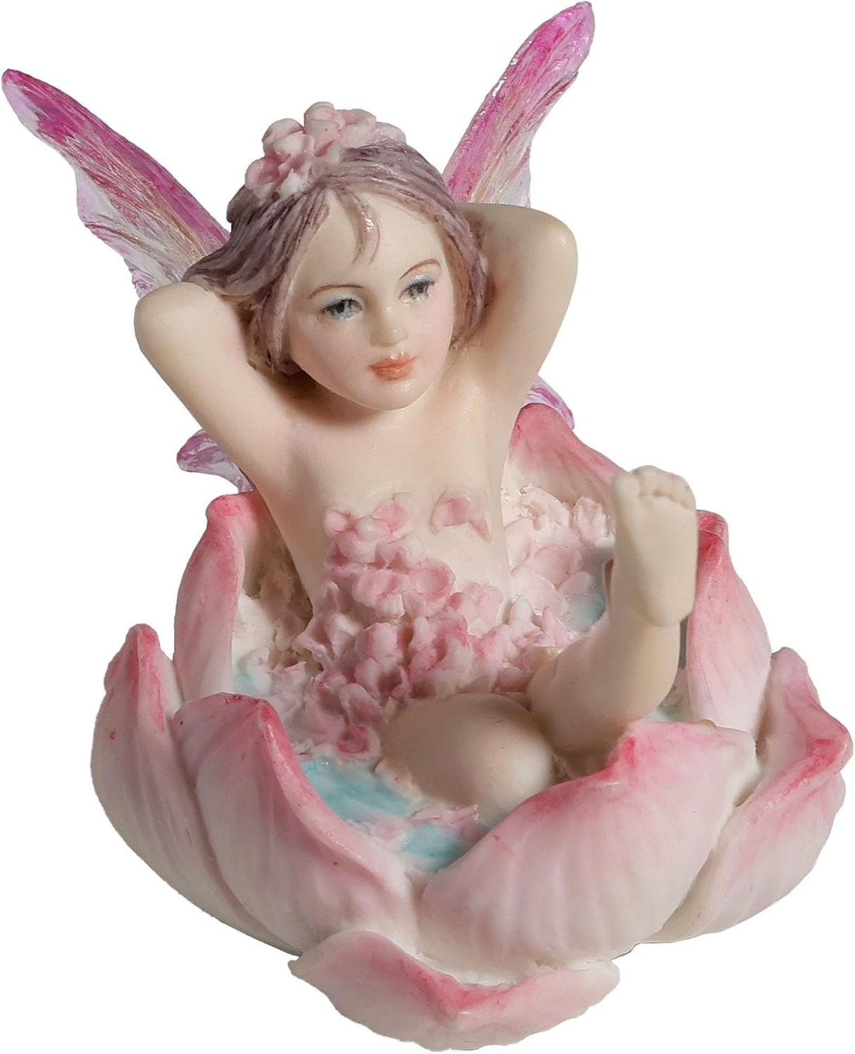 Figurine of a fairy with transparent wings in pink and clear reclining in a flower to have a bath, covered in pink petals