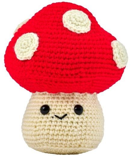 Crocheted mushroom with red top and a face on the stem