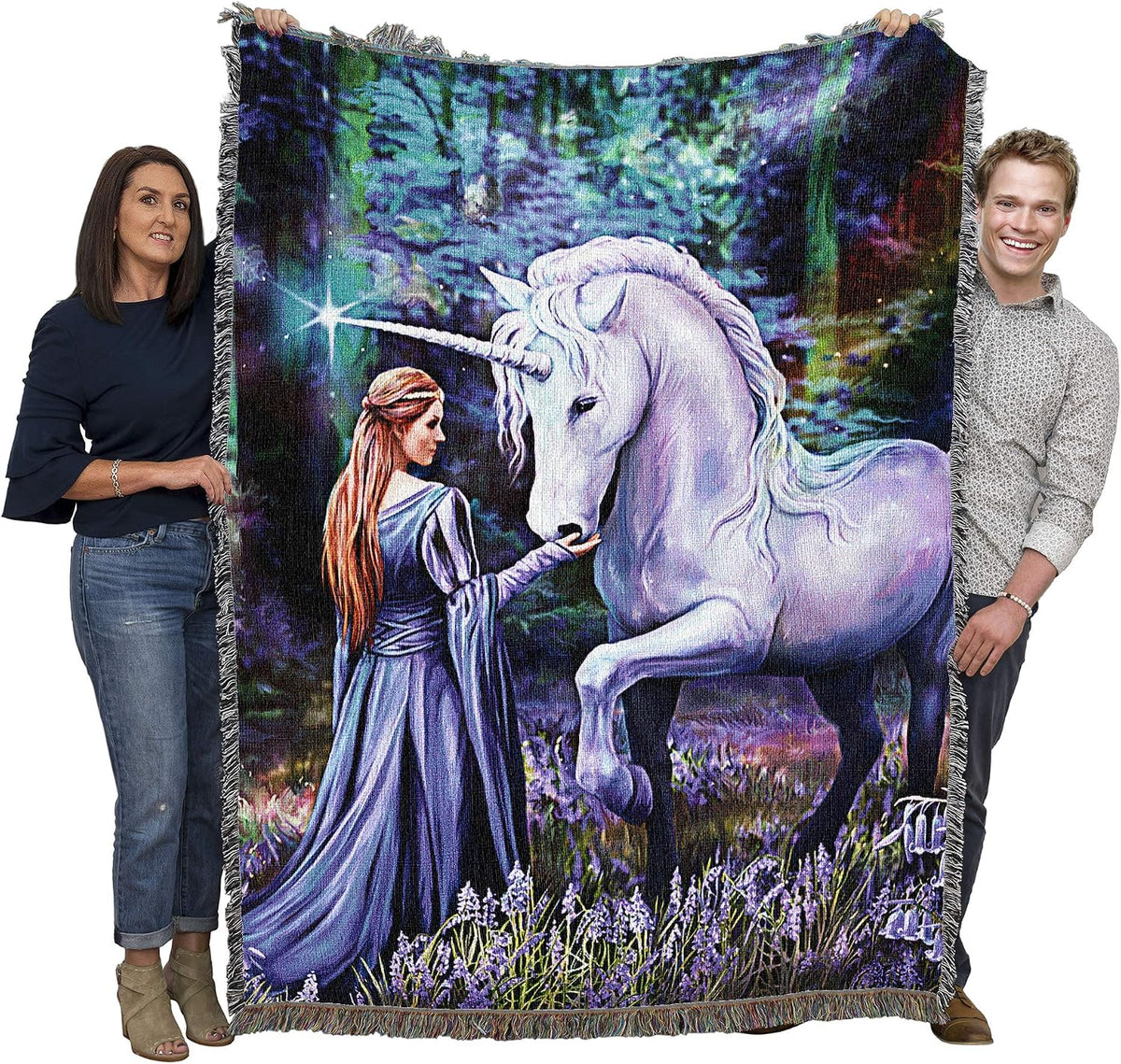 Tapestry blanket with unicorn and maiden in bluebell-filled forest meadow, held up by two adults