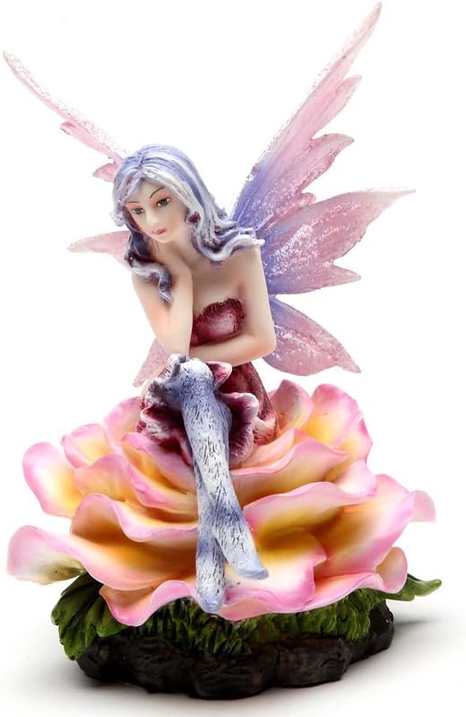 Figurine of purple haired fairy with pink wings and magenta dress sitting on a peach and yellow flower blossom