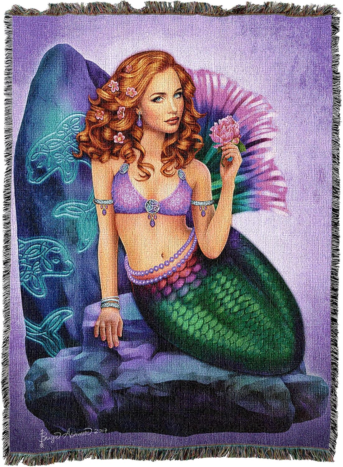 Tapestry blanket, art by Brigid Ashwood, mermaid with mostly green tail, fins in purple and pink. Red hair, holding pink flower, sitting against stone carved with Celtic knotwork dolphins