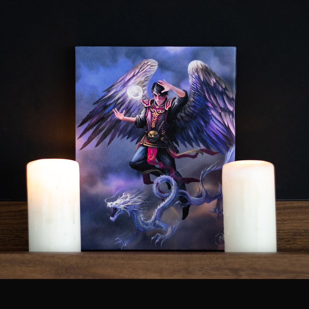 Canvas print by Anne Stokes, winged air wizard with glowing orb flying with Asian dragon in the cloudy sky