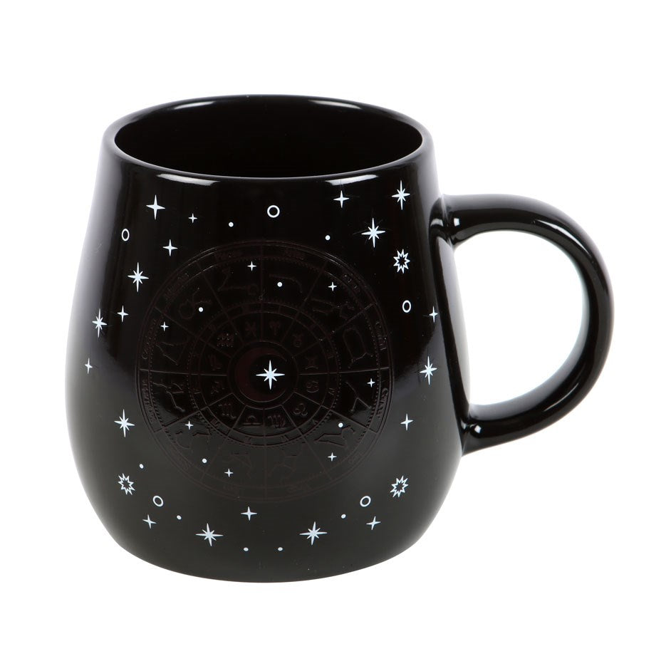 Black ceramic mug with gold astrology wheel that shows up with heat