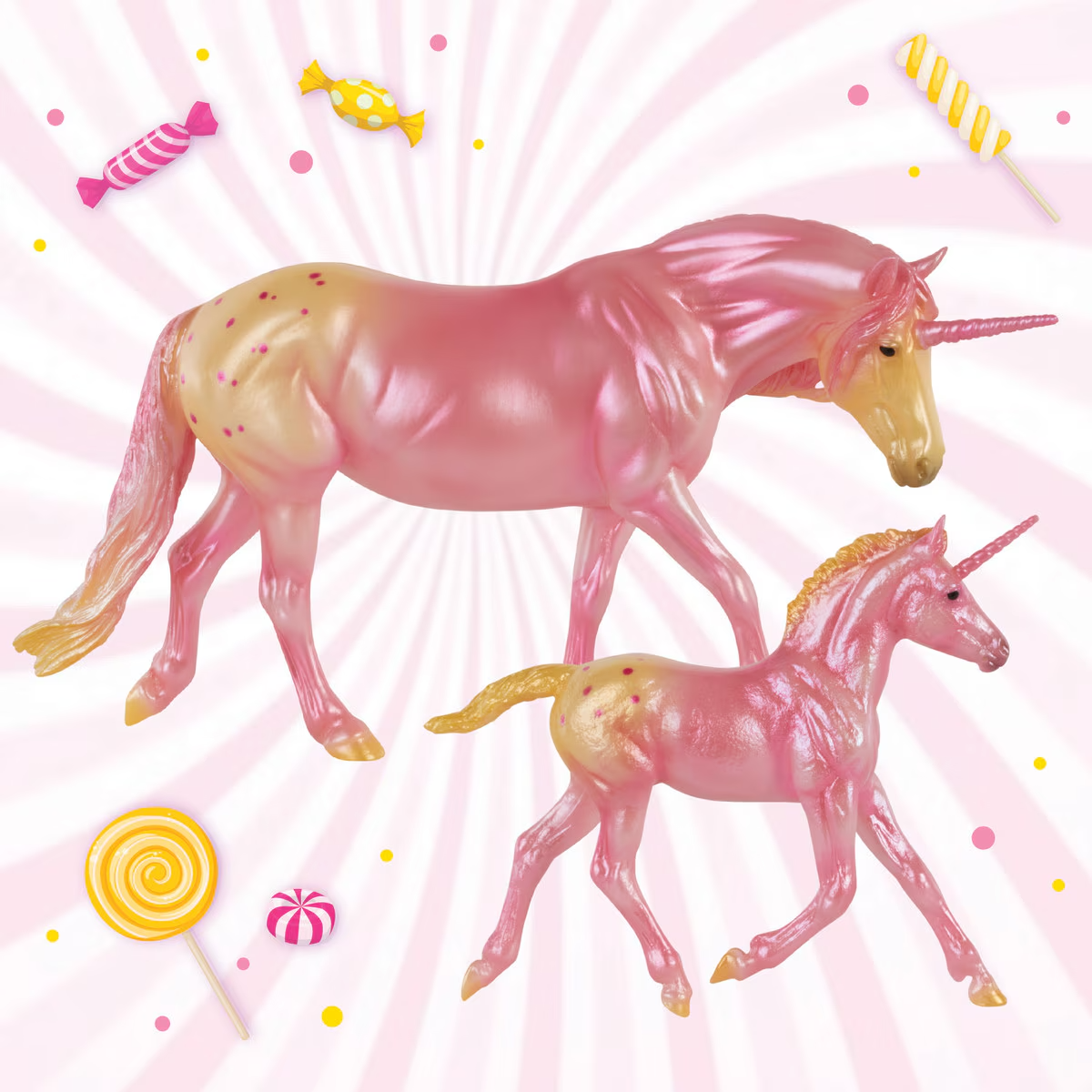 Model horse figurines, mare and foal, two appaloosa unicorns in pink and cream colors, shown with candy