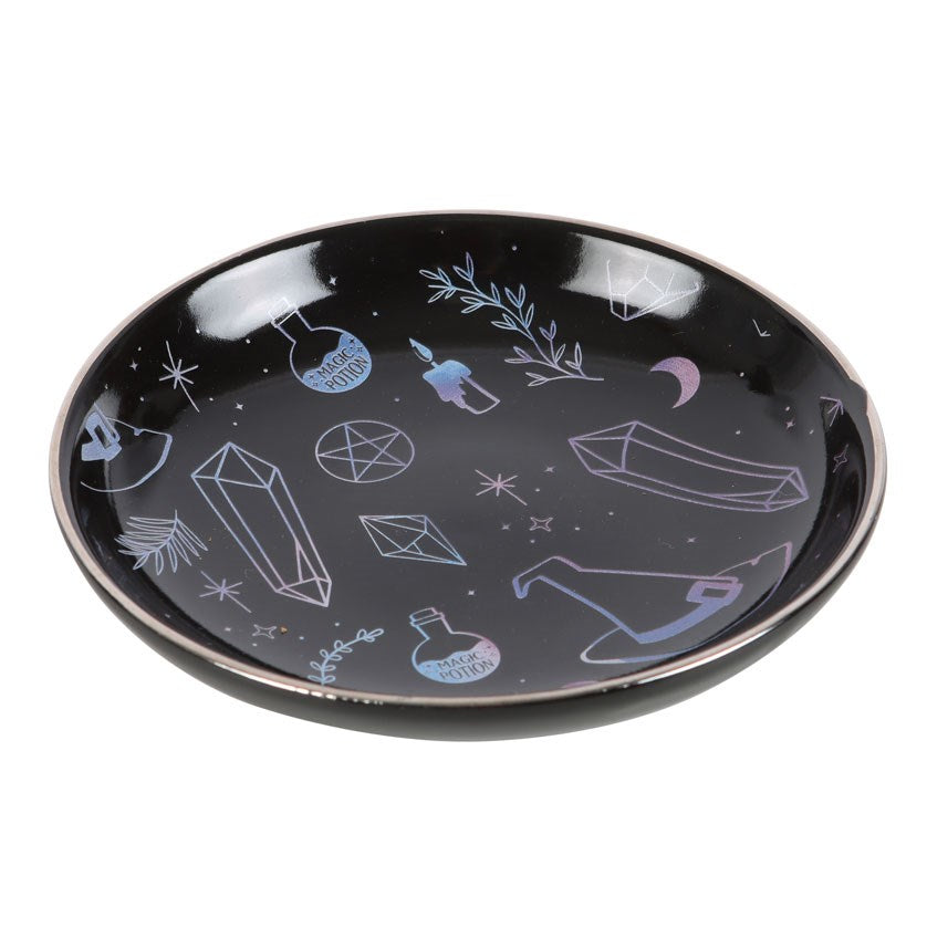 Round trinket dish with witchy designs of hat, crystals, plants, candles in gradient blue purple on black background